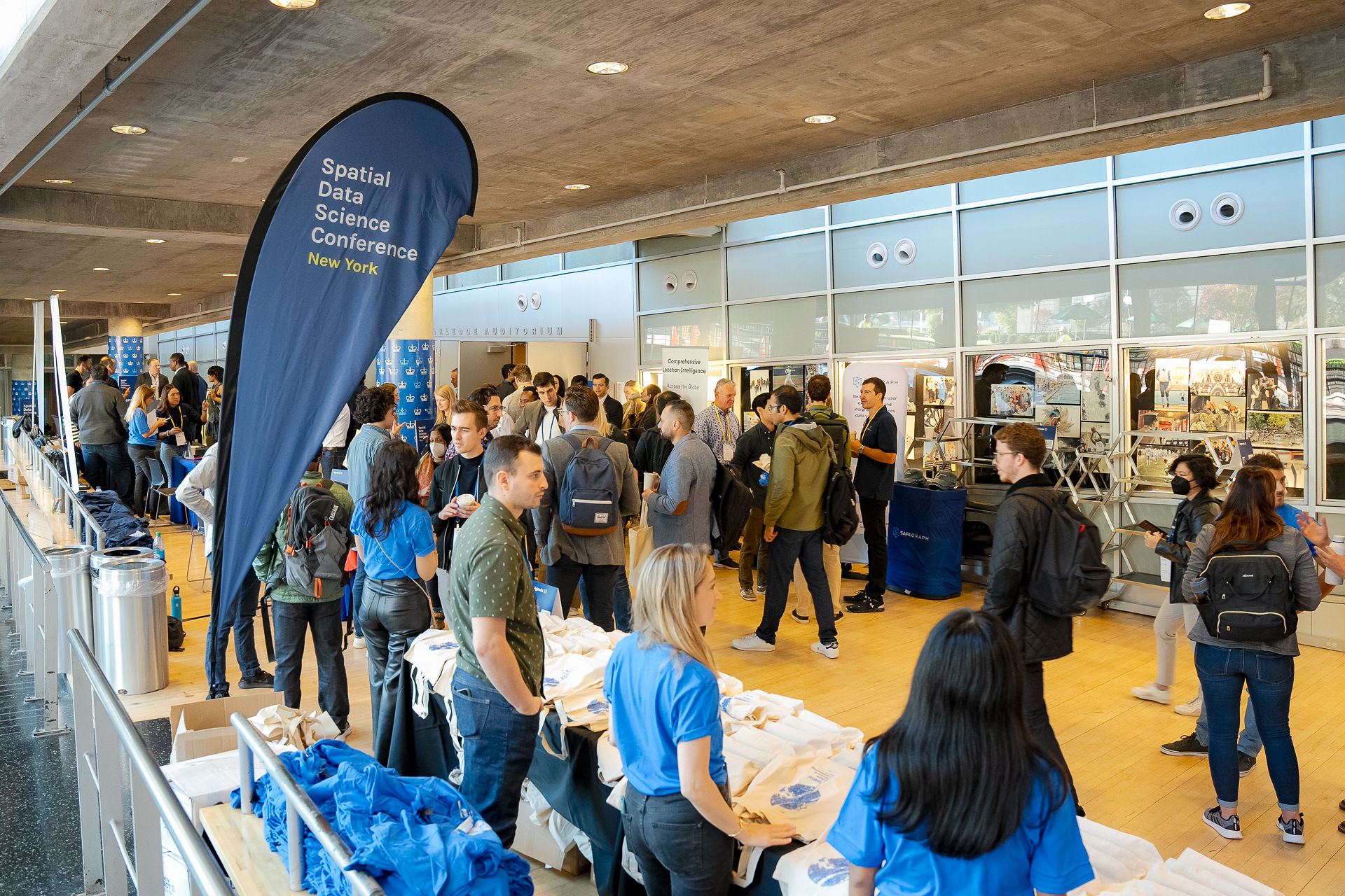 Attendees arriving in the conference registration and merchandise area