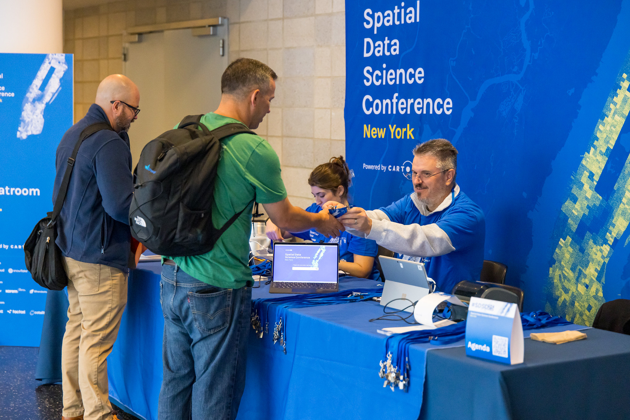 Spatial Data Science Conference registration desk, backdrop and attendee materials