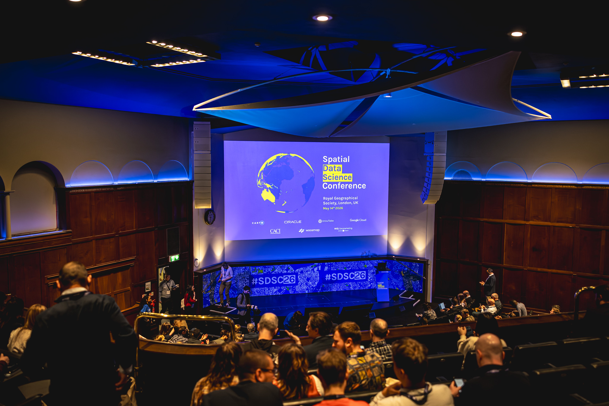 Spatial Data Science Conference stage, screens, backdrop and auditorium environment